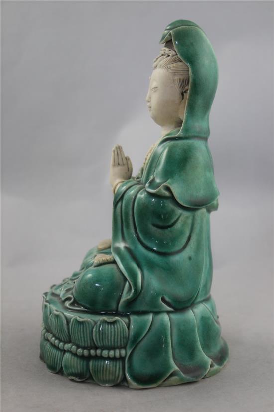 A Chinese green glazed biscuit porcelain seated figure of Guanyin, 12cm